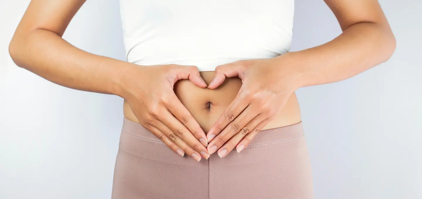 Woman holding stomach, apple cider vinegar capsules for digestive health
