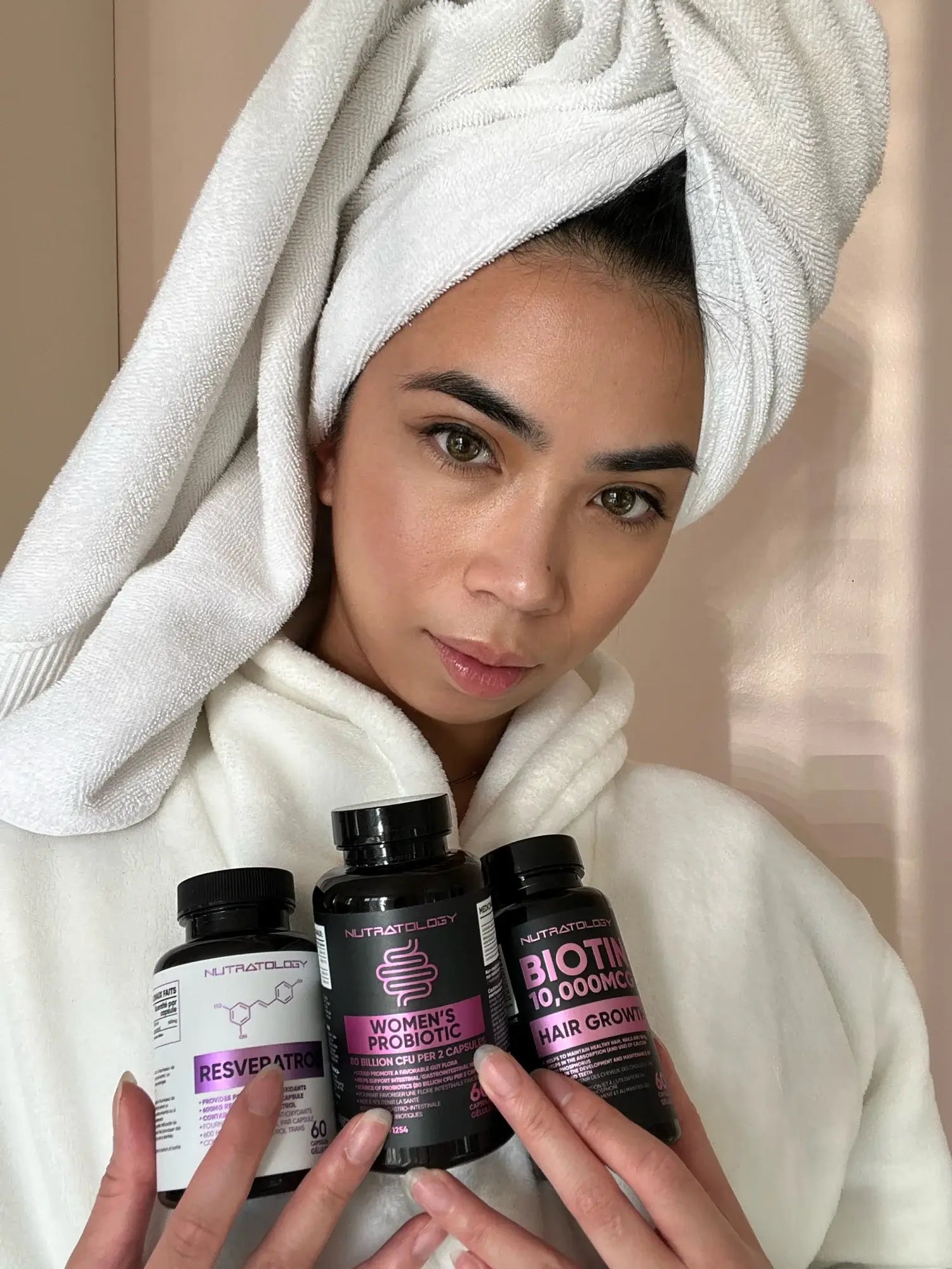 Woman holding Nutratology Supplement Bundle For Her - Biotin Supplement - Resveratrol Supplement - Women's Probiotic Supplement